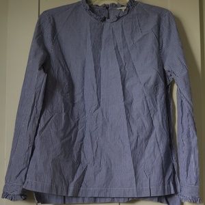 Striped shirt with ruffles on cuffs and neck.